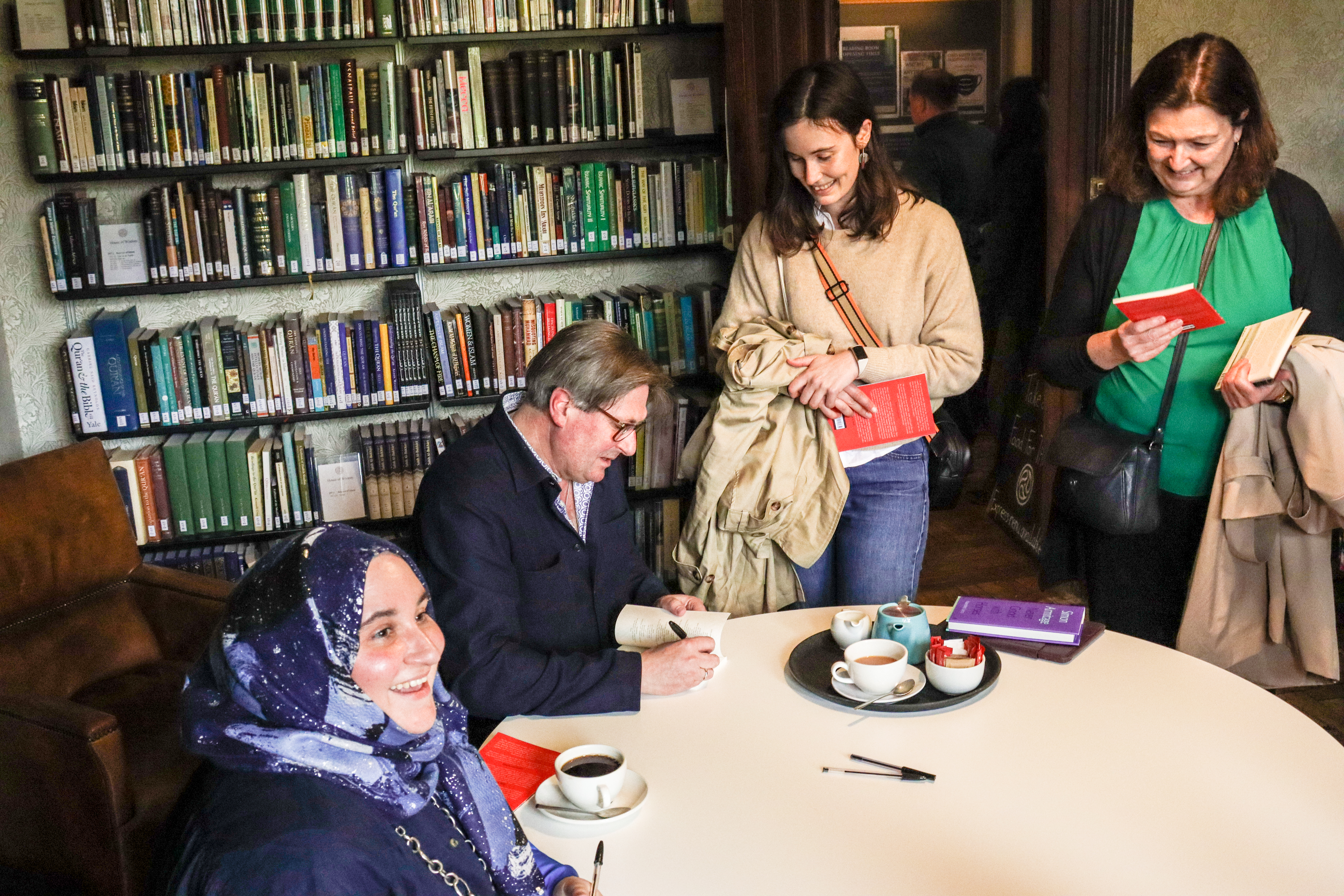 Simon Armitage signing books in the House of Wisdom