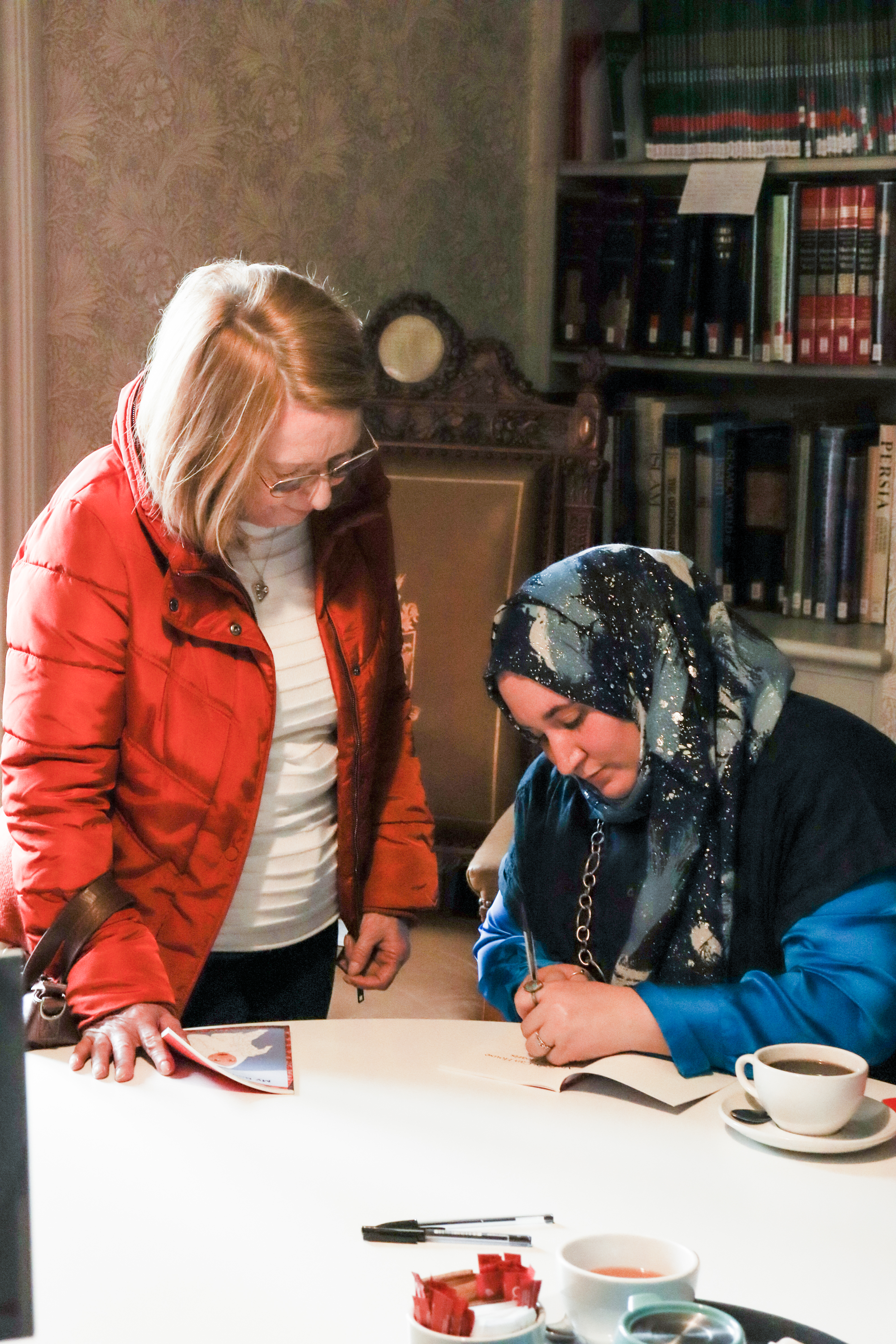 Hanan Issa signing a poetry book