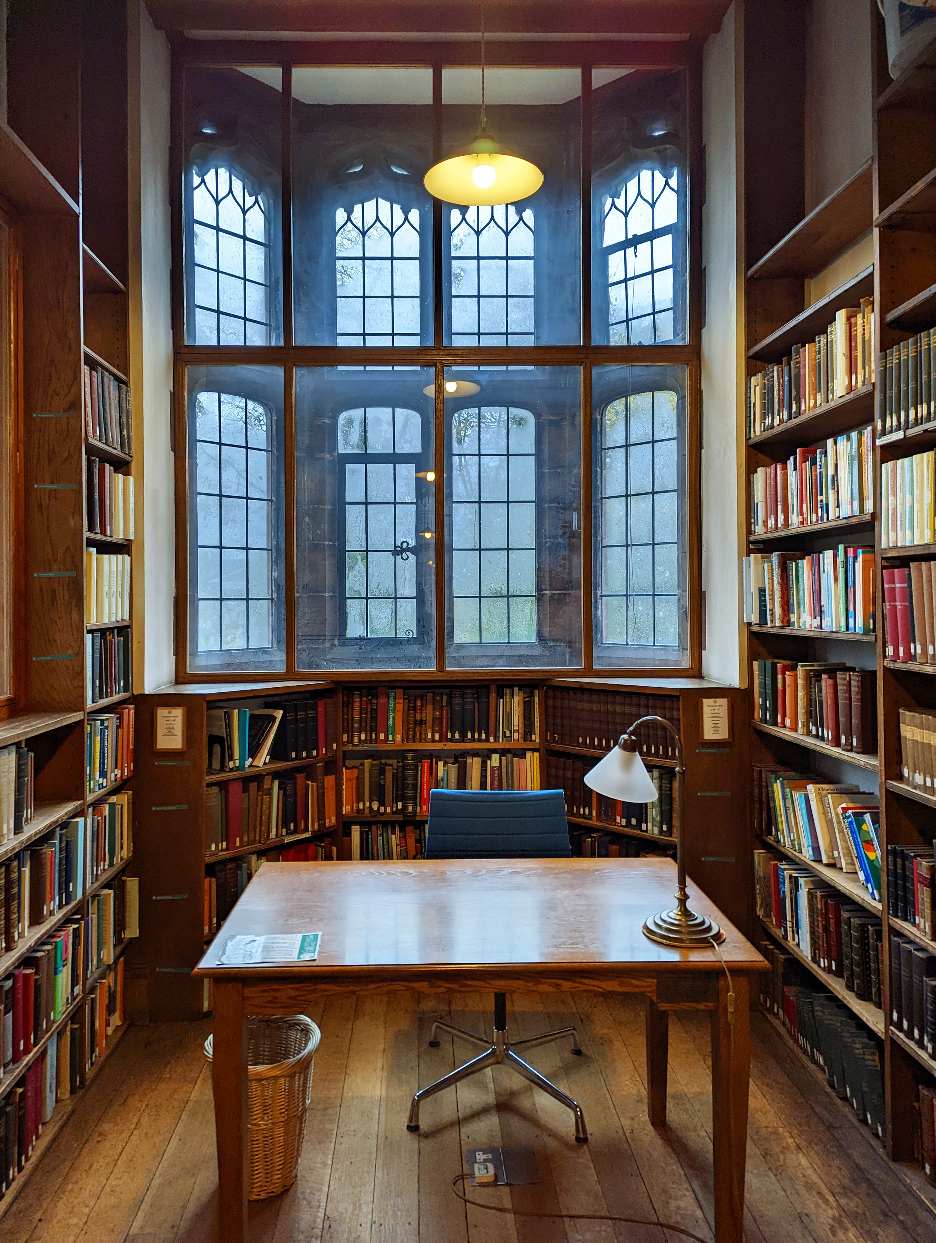 A view of a desk in front of a bay window