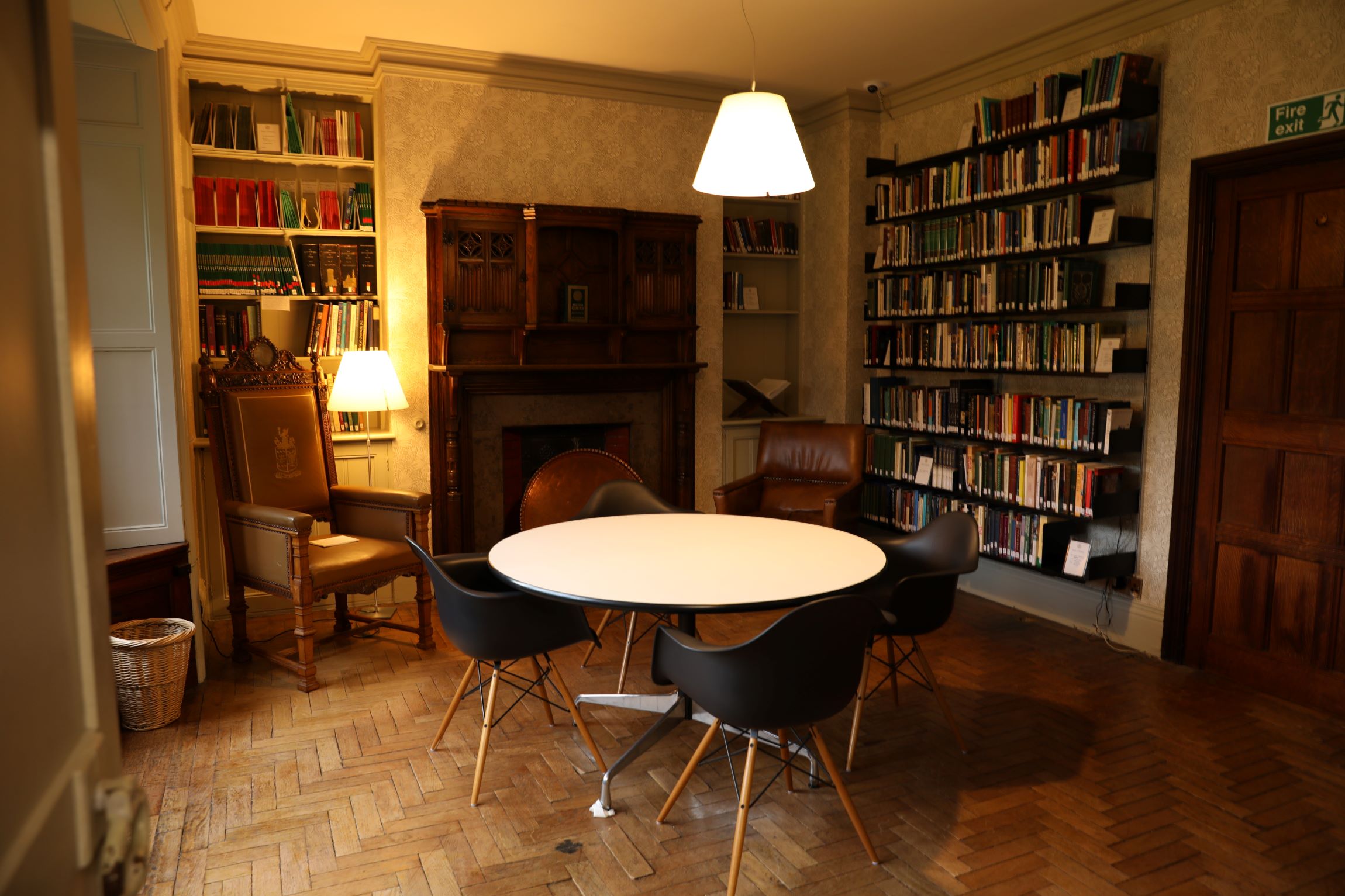 A picture of the House of Wisdom Reading Room. There are bookshelves on the walls and there is a round white table in the centre