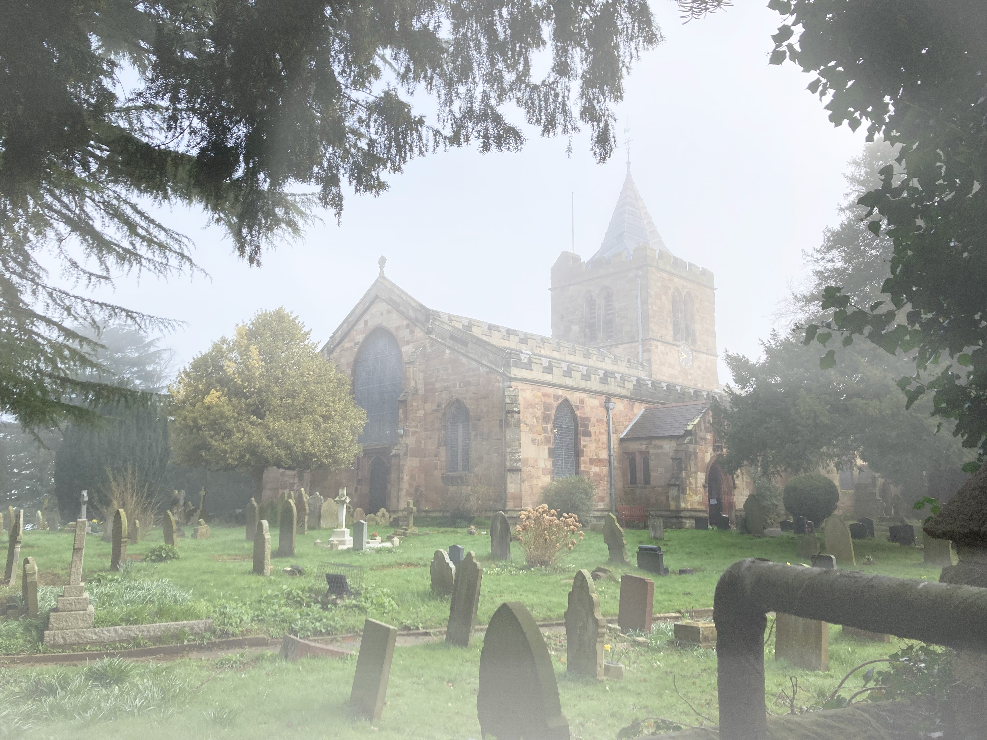 A photograph of St Deiniol's church and graveyard