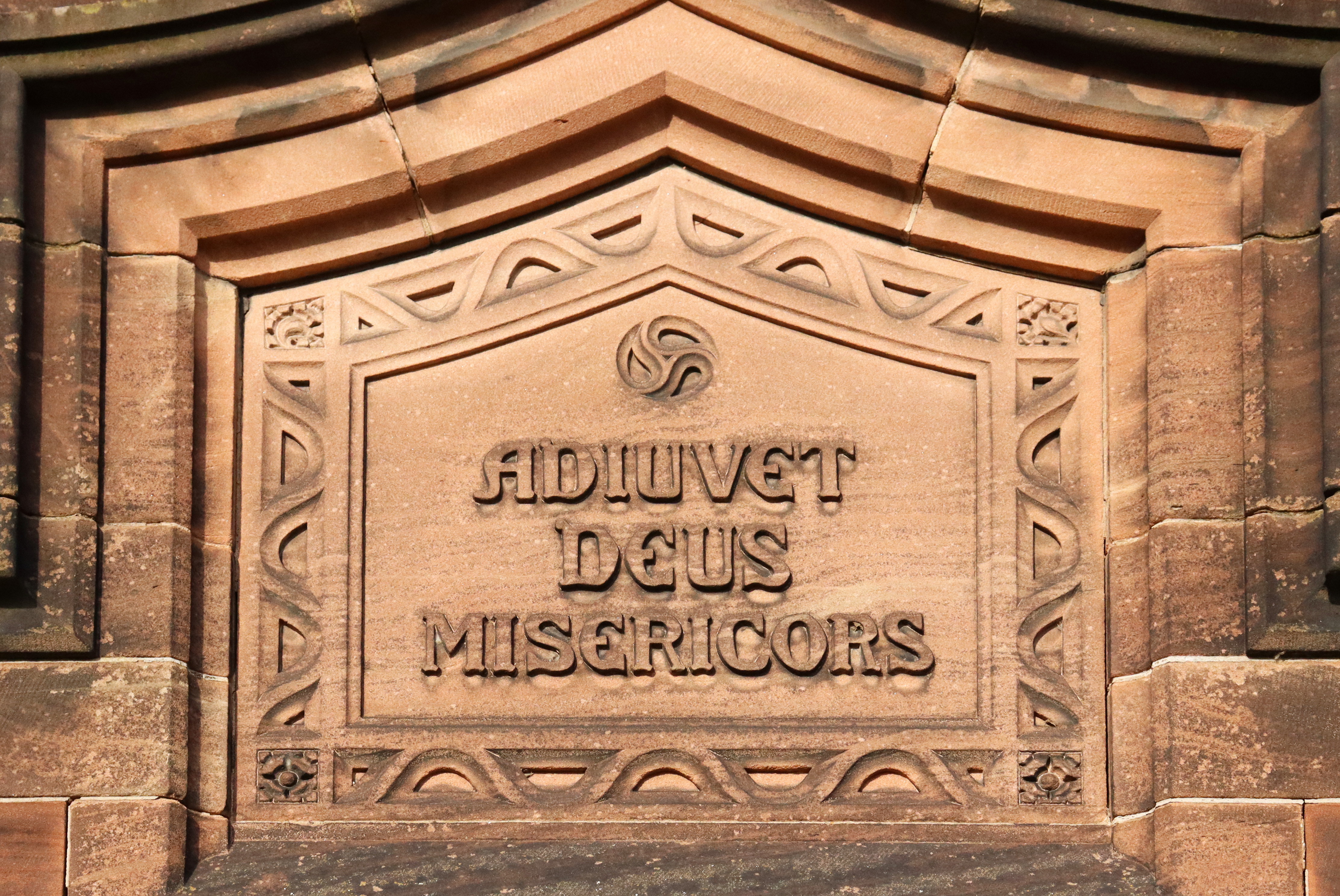 The carved stone motto